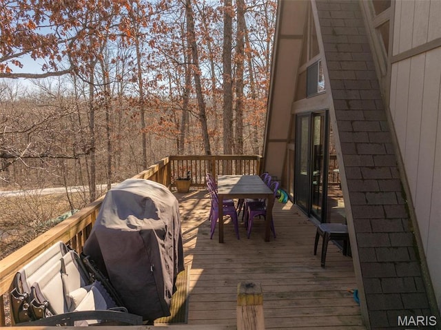 1758 Turrach Dr, Innsbrook, MO 63390 - wooden terrace with outdoor dining area, grilling area, and a forest view