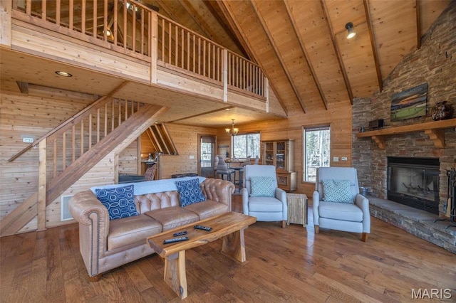 1758 Turrach Dr, Innsbrook, MO 63390 - living area featuring high vaulted ceiling, stairs, wood ceiling with exposed beams, hardwood / wood-style flooring, and a fireplace