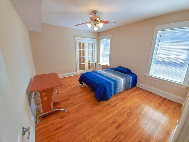 760 Syracuse Ave, University City, MO 63130 - unfurnished bedroom featuring baseboards, light wood-type flooring, a ceiling fan, and french doors