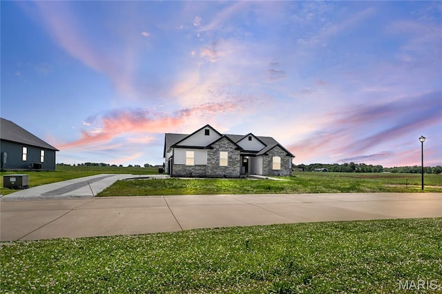 1002 Brianna Ct, Jerseyville, IL 62052 - view of front of house featuring stone siding, concrete driveway, and a yard