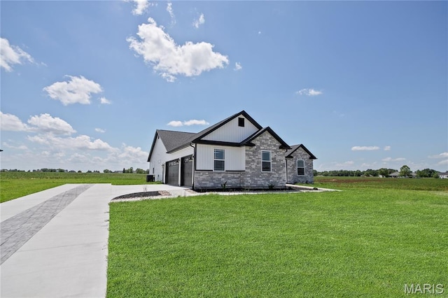 1002 Brianna Ct, Jerseyville, IL 62052 - view of front of property featuring driveway, an attached garage, a front lawn, and stone siding