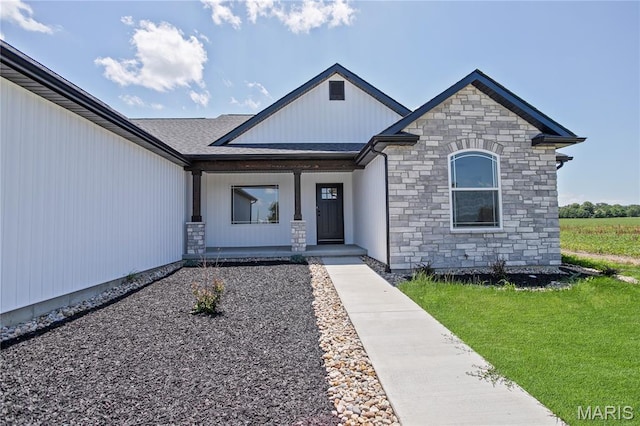 1002 Brianna Ct, Jerseyville, IL 62052 - view of front of home featuring stone siding, covered porch, and a front yard