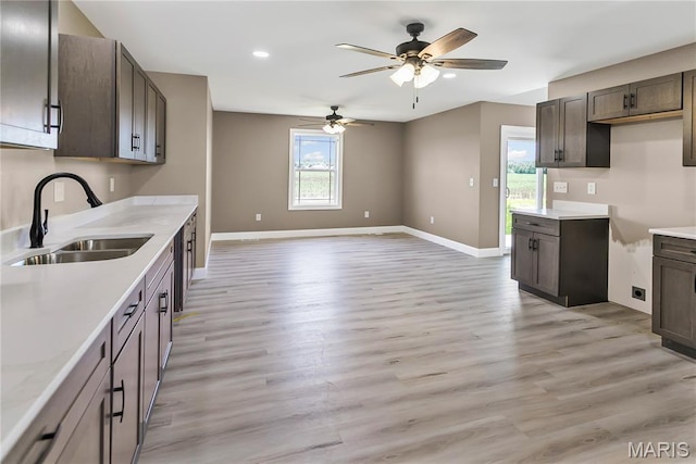 1002 Brianna Ct, Jerseyville, IL 62052 - kitchen featuring dark brown cabinets, ceiling fan, light wood-style floors, and recessed lighting