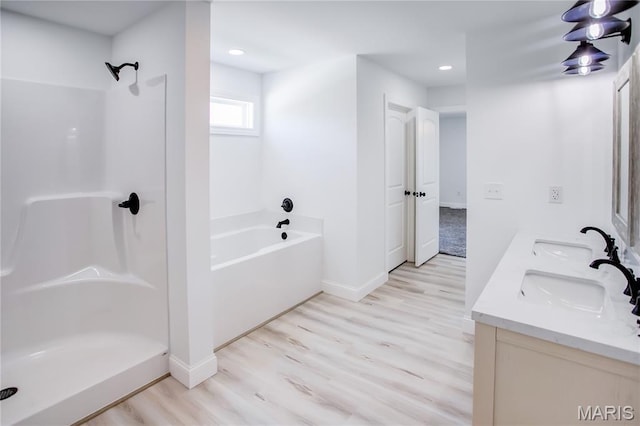1002 Brianna Ct, Jerseyville, IL 62052 - full bathroom featuring wood finished floors, double vanity, a bath, recessed lighting, and a shower