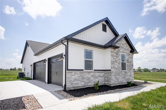 1002 Brianna Ct, Jerseyville, IL 62052 - view of side of property with stone siding, a garage, concrete driveway, and board and batten siding