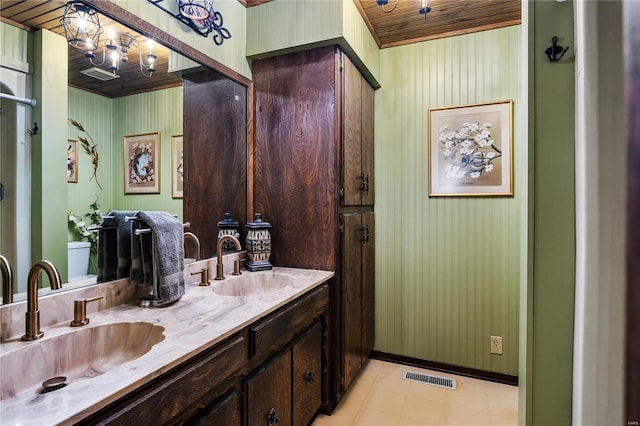 6492 State Highway 25, Dexter, MO 63841 - bathroom featuring double vanity, a chandelier, wood ceiling, and baseboards