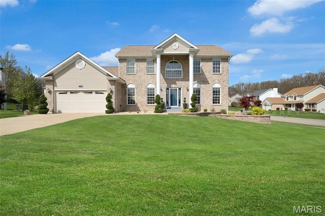 1101 Panda Ct, Wentzville, MO 63385 - greek revival inspired property featuring a garage, a front yard, driveway, and brick siding