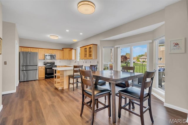 1101 Panda Ct, Wentzville, MO 63385 - dining area featuring baseboards, dark wood finished floors, and recessed lighting