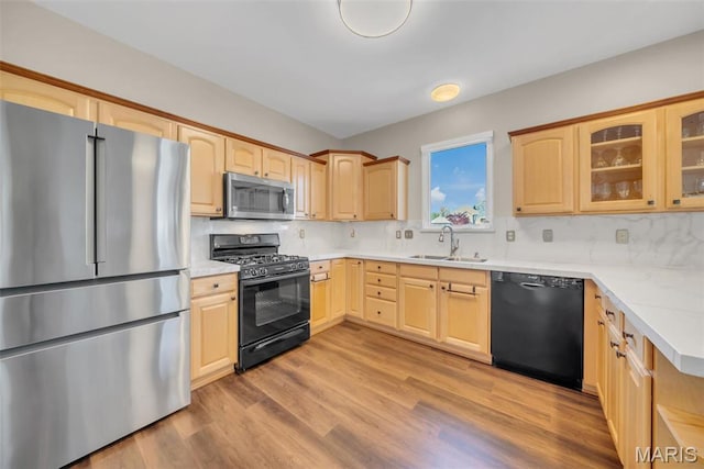 1101 Panda Ct, Wentzville, MO 63385 - kitchen with black appliances, a sink, light brown cabinets, and glass insert cabinets