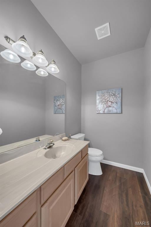 1101 Panda Ct, Wentzville, MO 63385 - bathroom with vanity, toilet, wood finished floors, and baseboards