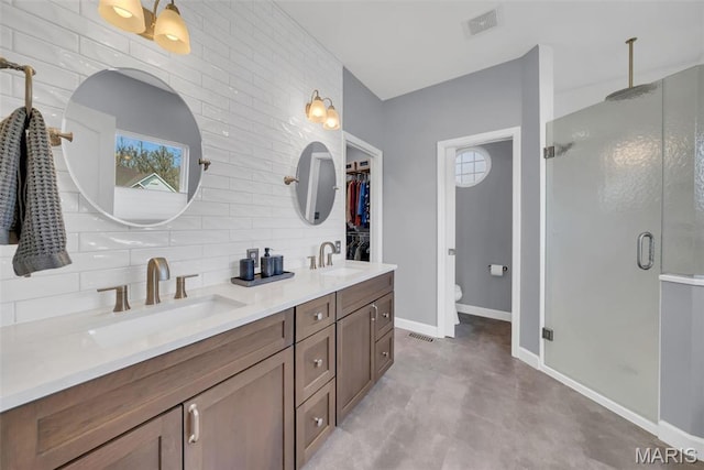 1101 Panda Ct, Wentzville, MO 63385 - bathroom featuring a shower stall, finished concrete flooring, baseboards, and double vanity