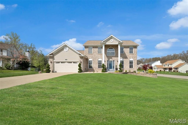 1101 Panda Ct, Wentzville, MO 63385 - neoclassical home featuring concrete driveway, a front yard, an attached garage, and brick siding