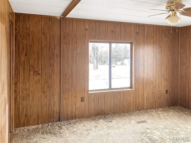 307 Silvey, Fayette, MO 65248 - spare room with wooden walls, a ceiling fan, and carpet