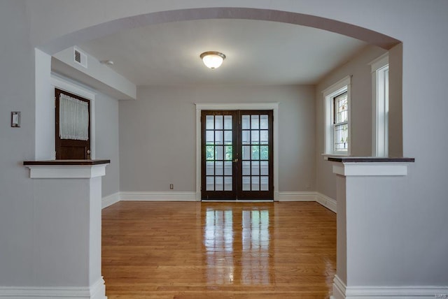 750 Leland Ave, University City, MO 63130 - doorway featuring wood finished floors, baseboards, french doors, and arched walkways
