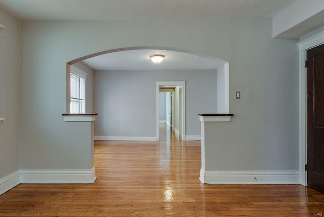 750 Leland Ave, University City, MO 63130 - spare room with light wood-style floors, baseboards, and arched walkways