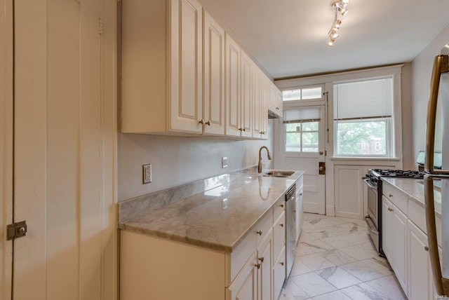 750 Leland Ave, University City, MO 63130 - kitchen featuring a sink, stainless steel appliances, light marble finish floors, and light stone countertops
