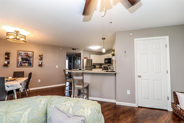 living room featuring a ceiling fan, dark wood finished floors, and baseboards