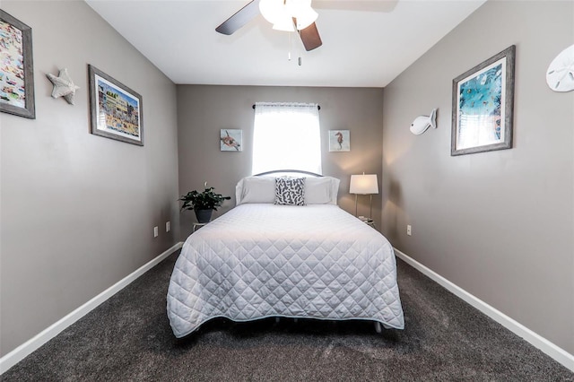 bedroom featuring dark colored carpet, baseboards, and a ceiling fan