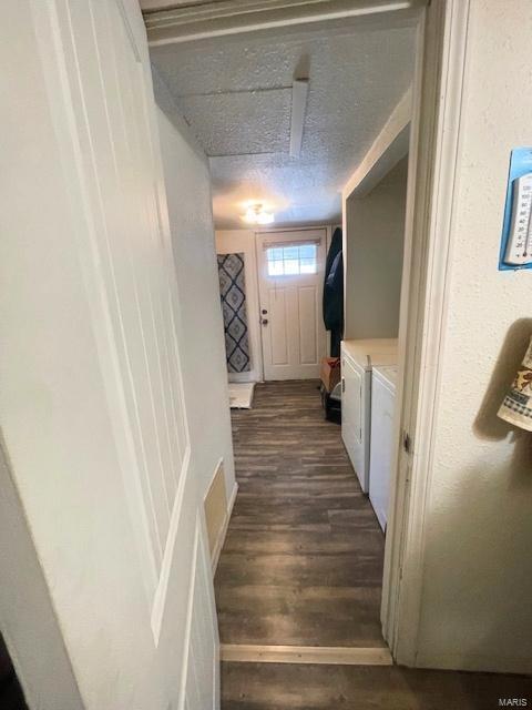 659 W 4th St, Lebanon, MO 65536 - doorway featuring washer and dryer, dark wood-type flooring, and a textured ceiling