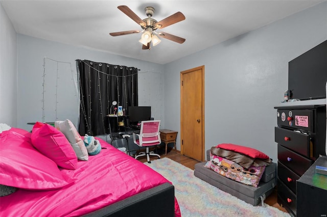 bedroom with wood finished floors and a ceiling fan