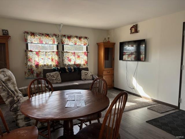 dining room featuring light wood-style floors and baseboards