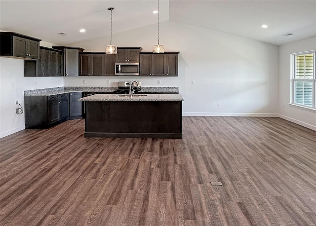 624 Rhapsody, Troy, IL 62294 - kitchen featuring appliances with stainless steel finishes, baseboards, lofted ceiling, dark wood-type flooring, and an island with sink