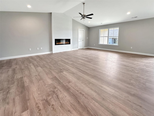 624 Rhapsody, Troy, IL 62294 - unfurnished living room with ceiling fan, wood finished floors, vaulted ceiling, and baseboards