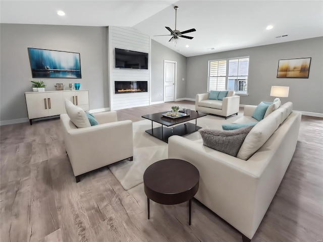 624 Rhapsody, Troy, IL 62294 - living area with a ceiling fan, wood finished floors, baseboards, lofted ceiling, and a large fireplace