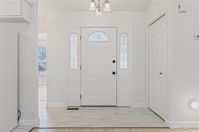 3216 E Leverett Ct, Alton, IL 62002 - entryway with light marble finish flooring, baseboards, and a chandelier