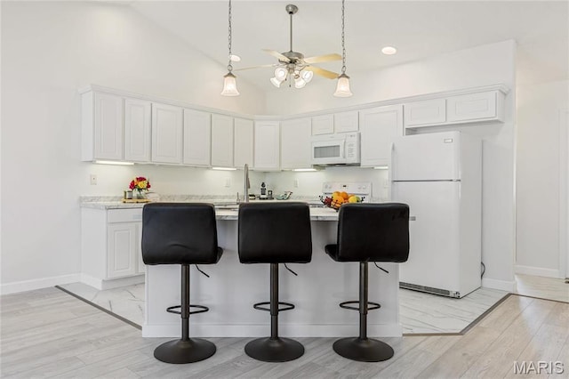 3216 E Leverett Ct, Alton, IL 62002 - kitchen with white appliances, baseboards, light countertops, white cabinetry, and high vaulted ceiling