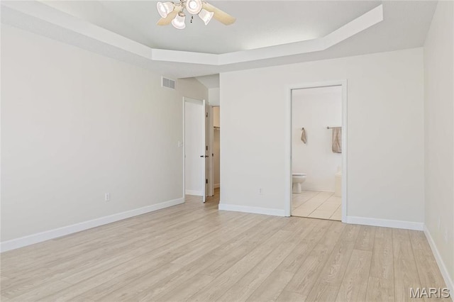 3216 E Leverett Ct, Alton, IL 62002 - unfurnished bedroom with light wood-style flooring, a raised ceiling, ensuite bathroom, baseboards, and ceiling fan