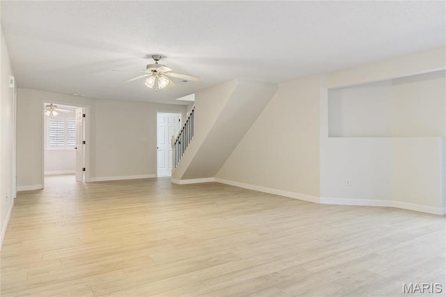 3216 E Leverett Ct, Alton, IL 62002 - unfurnished living room featuring ceiling fan, baseboards, light wood finished floors, and stairway