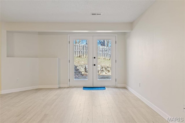 3216 E Leverett Ct, Alton, IL 62002 - doorway to outside with french doors, light wood-type flooring, baseboards, and a textured ceiling