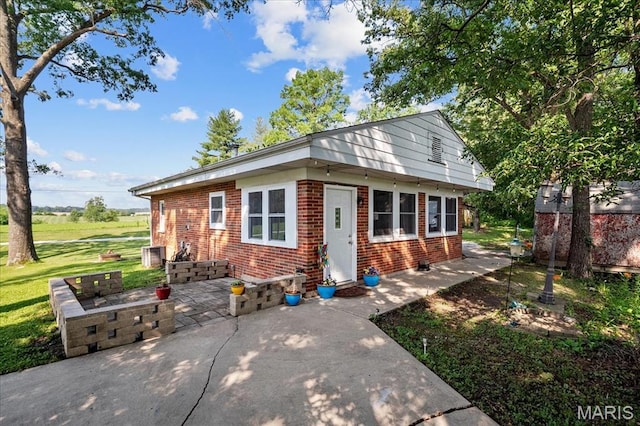 6405 S Ronnie Dr, Waterloo, IL 62298 - bungalow-style home featuring brick siding, a patio area, and a front lawn