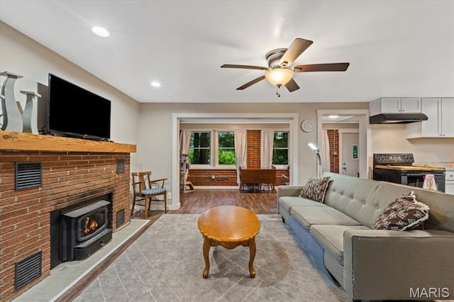 6405 S Ronnie Dr, Waterloo, IL 62298 - living room with wood finished floors, ceiling fan, a wood stove, and recessed lighting
