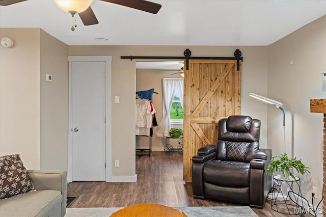 6405 S Ronnie Dr, Waterloo, IL 62298 - living area with a barn door, wood finished floors, and a ceiling fan