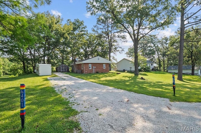 6405 S Ronnie Dr, Waterloo, IL 62298 - view of front facade with driveway, brick siding, and a front lawn