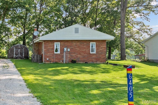 6405 S Ronnie Dr, Waterloo, IL 62298 - view of side of property with a yard, brick siding, and a storage shed