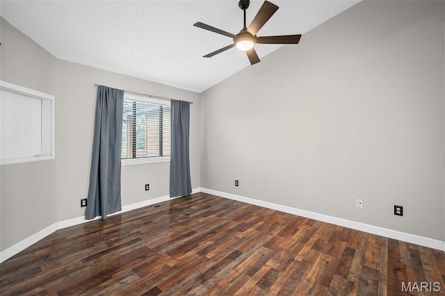 unfurnished room with lofted ceiling, a ceiling fan, wood finished floors, and baseboards