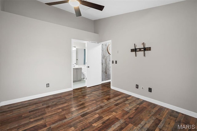empty room with ceiling fan, baseboards, wood finished floors, and high vaulted ceiling