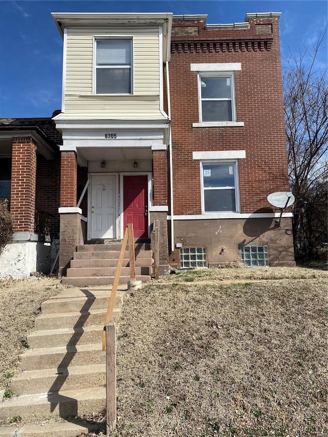 view of front facade featuring brick siding and entry steps