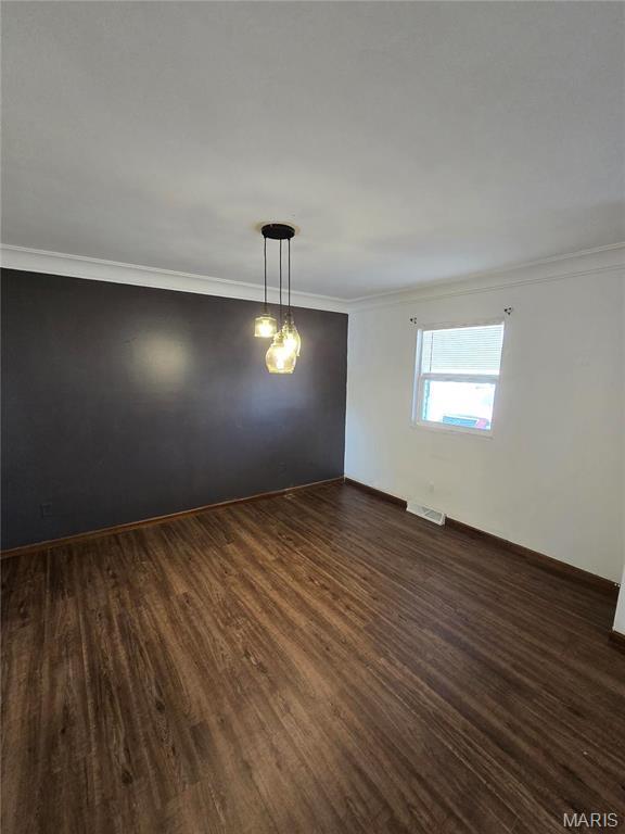 423 Virginia St, Granite City, IL 62040 - spare room with ornamental molding, dark wood-style floors, and baseboards
