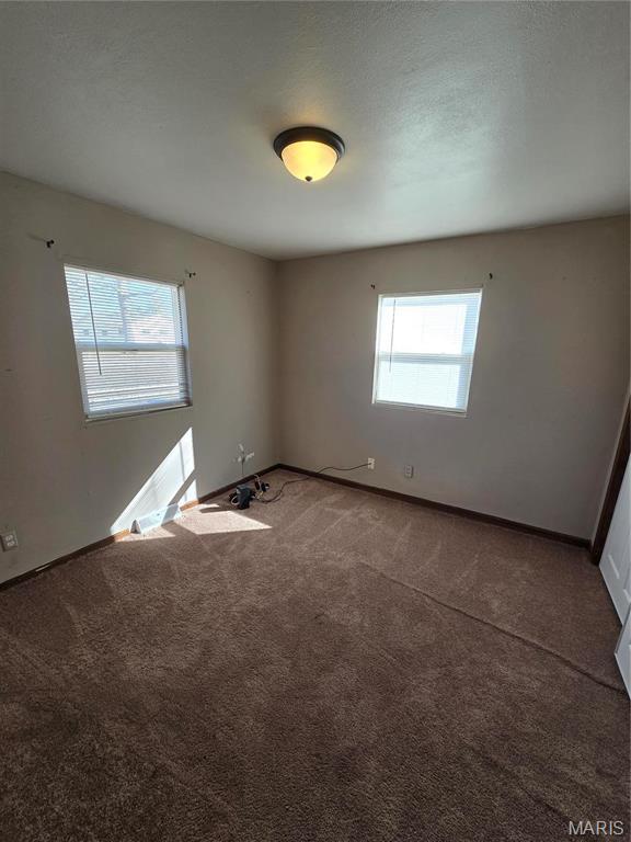 423 Virginia St, Granite City, IL 62040 - carpeted spare room featuring baseboards