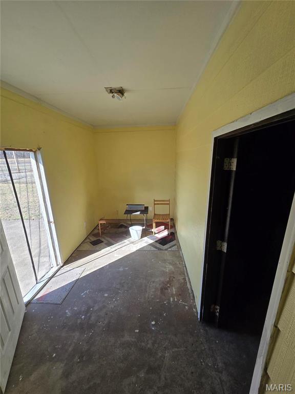 423 Virginia St, Granite City, IL 62040 - spare room with ornamental molding and lofted ceiling