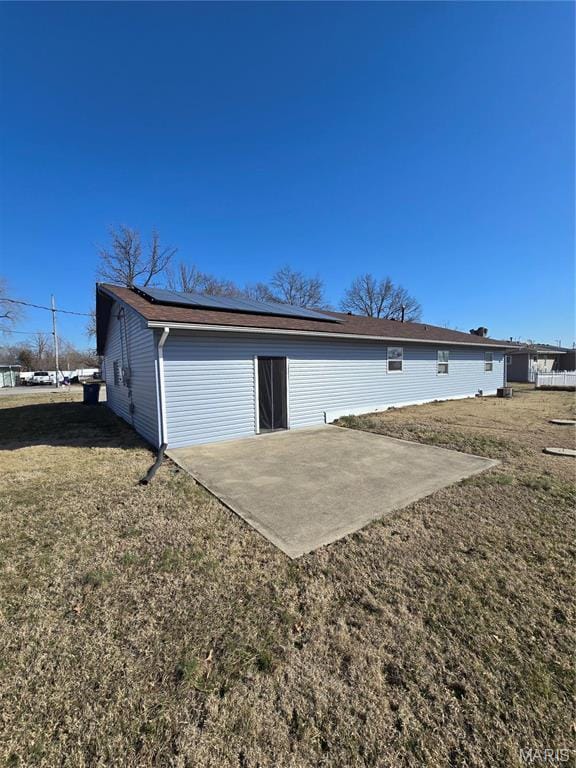 423 Virginia St, Granite City, IL 62040 - rear view of property with a patio, solar panels, and a lawn