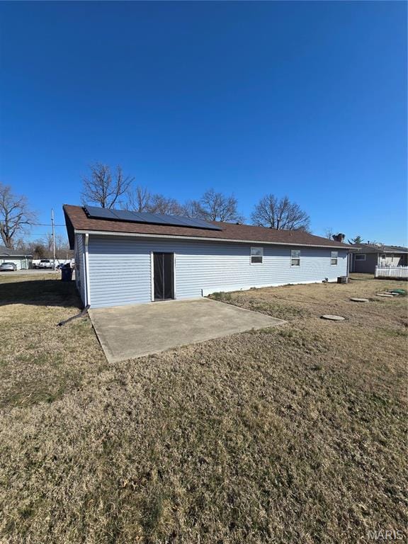 423 Virginia St, Granite City, IL 62040 - back of house with a patio area, roof mounted solar panels, and a yard