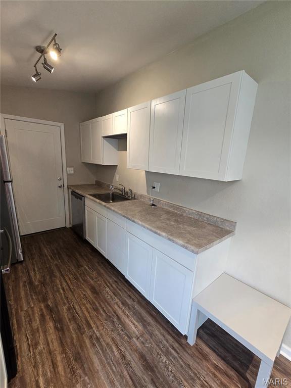 4536 Walter Ave, Granite City, IL 62040 - kitchen featuring a sink, white cabinets, dark wood-type flooring, stainless steel dishwasher, and light countertops