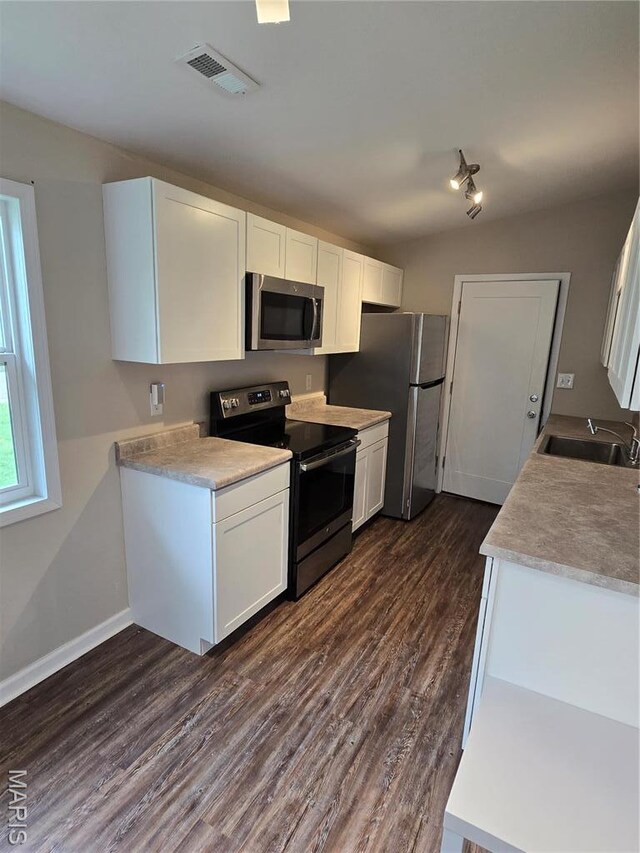 4536 Walter Ave, Granite City, IL 62040 - kitchen featuring stainless steel appliances, a sink, dark wood-style floors, white cabinets, and light countertops