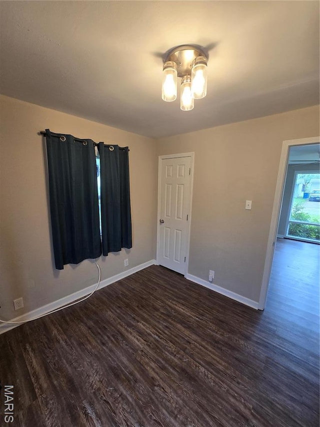 4536 Walter Ave, Granite City, IL 62040 - unfurnished room with dark wood finished floors, a chandelier, and baseboards