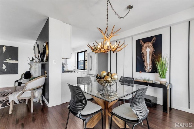 4466 W Pine Blvd Unit 8E, Saint Louis, MO 63108 - dining space with a chandelier, wood finished floors, and baseboards